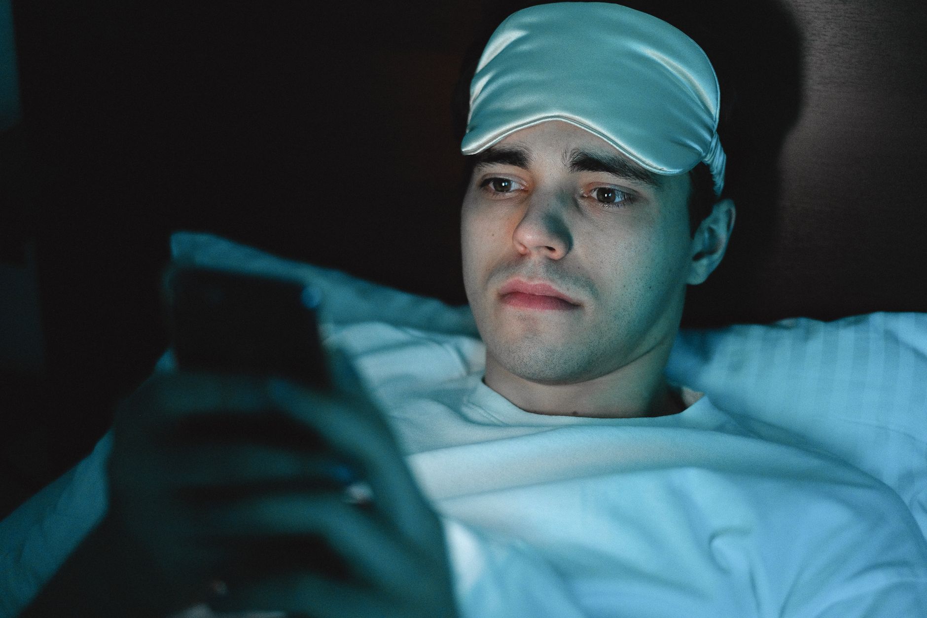 Person lying awake at night illustrating sleep deprivation in UK adults