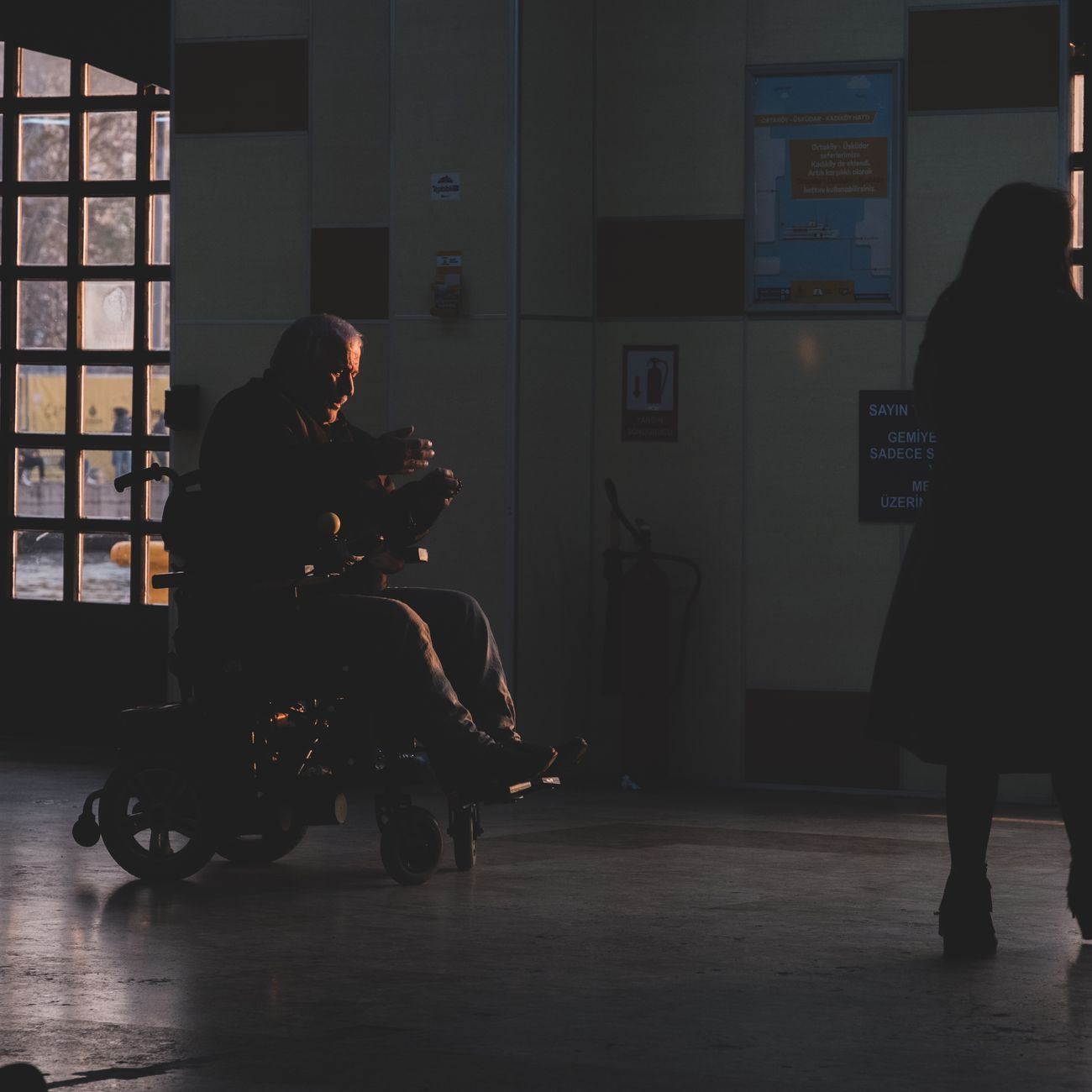 Person sitting alone in a hospital corridor, reflecting the reality behind NHS mental health waiting times