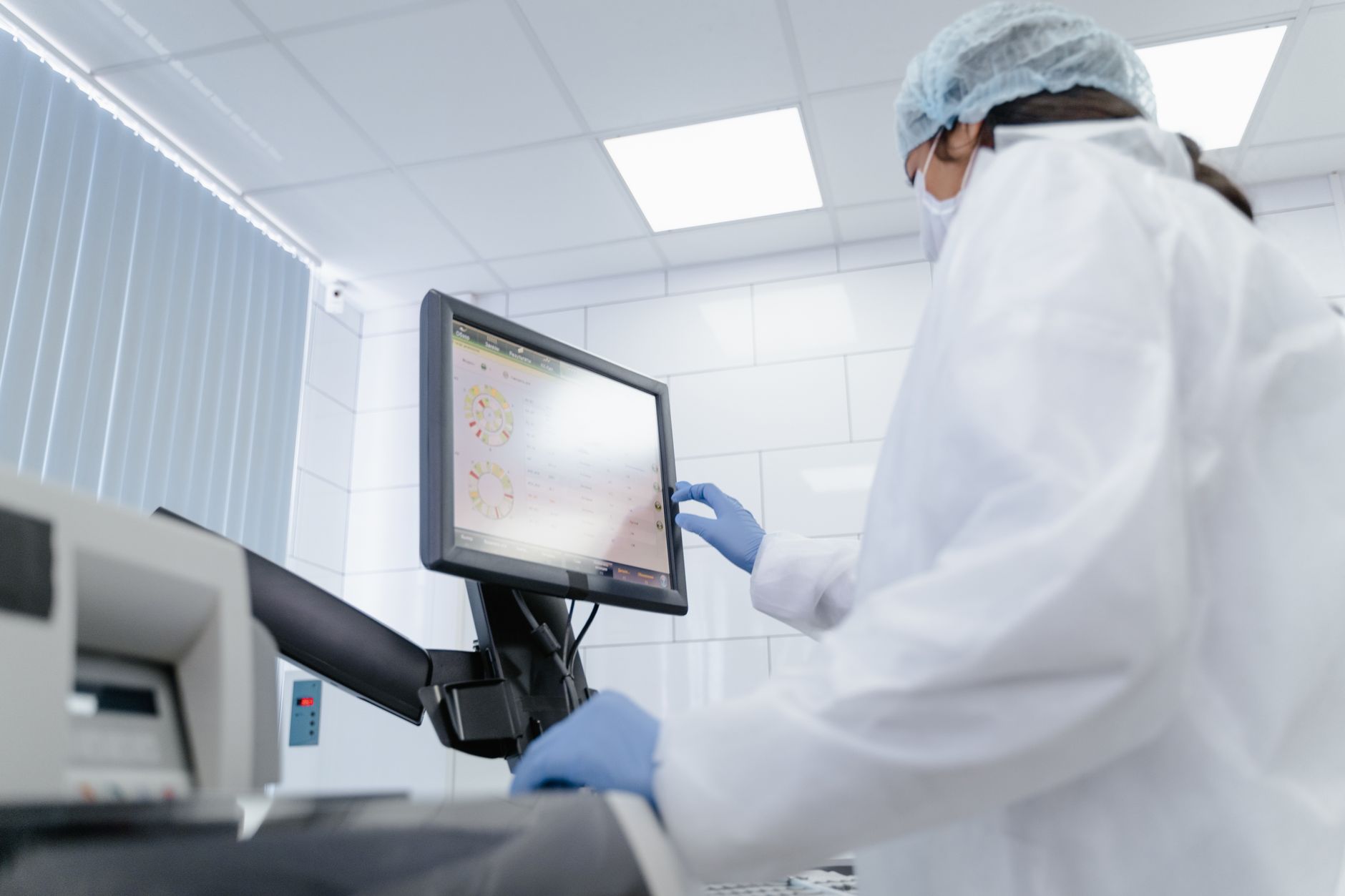 Scientist examining NHS genomic medicine UK sequencing data on a laboratory screen